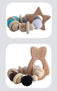 Detail of wooden baby teether with crochet beads and engraved animal shapes