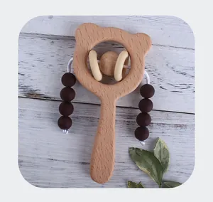 Detail of wooden bear rattle with silicone beads for infant teething and sensory play