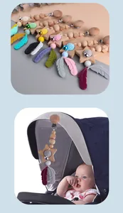 Baby pacifier clip with silicone beads, wooden stars, and feathers on a stroller