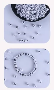 Detailed macro view of 7mm white acrylic square letter beads for DIY jewelry making