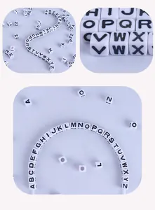 Macro detail of 7mm white acrylic square letter beads A-Z for DIY jewelry making