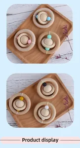 Detail showing natural wood baby teether with colorful silicone beads and planet shape design