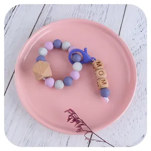 Silicone and beech wood baby teether bracelet with MOM engraved beads and lobster clasp