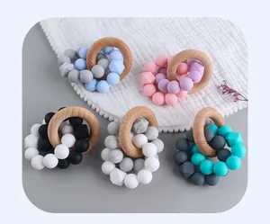 Close-up of baby teether sets with beech wood rings and multi-colored silicone beads