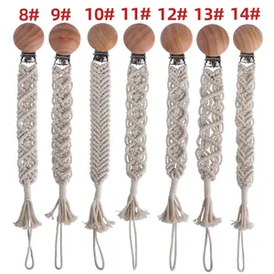 Detailed macro view of seven handmade macrame pacifier clips with beech wood grips