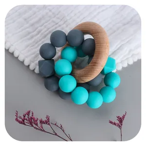 Baby teething ring with beech wood circle and colorful geometric silicone beads