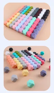 Macro detail of 17mm hexagonal silicone teething beads in various macaron colors and marble