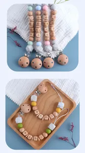 Detail showing silicone beads and beech wood pacifier clips with BABY letter engraving