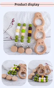 Detail of silicone beaded pacifier clips and avocado wooden teething rings for baby