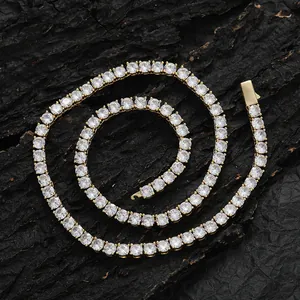 Macro shot of gold-plated tennis chain with round zircon stones on a dark bark background