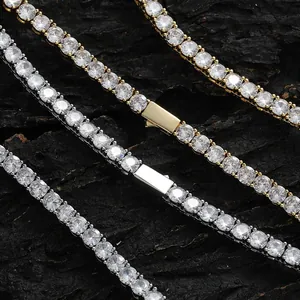 Silver and gold tennis chains with round cubic zirconia on a rustic wood background