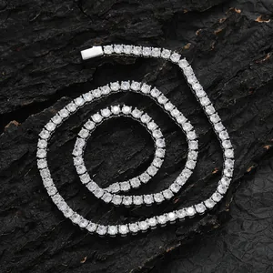 Detail of silver tennis necklace with round-cut zircons on black charcoal texture