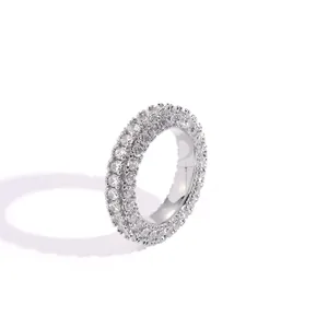Macro shot of silver hip-hop ring featuring three rows of pave-set cubic zirconia stones