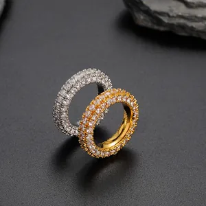 Macro detail of gold and silver plated hip-hop rings with full pave zircon stones