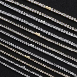 Macro detail of silver and gold tennis chains featuring round cubic zirconia and safety clasps