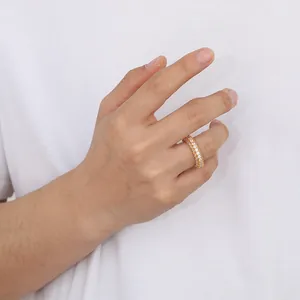 Close-up of triple-row gold eternity ring with zircon stones on female finger