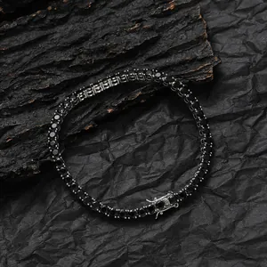 Macro shot of 3mm black zircon tennis bracelet with silver-tone clasp on rustic wood