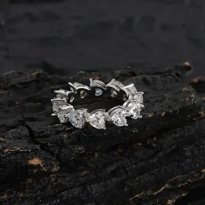 Macro view of 5mm heart-cut cubic zirconia stones on silver hip hop eternity ring