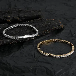 Detail of silver and gold tennis bracelets with 4-prong set cubic zirconia stones