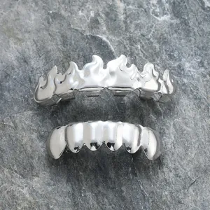 Polished silver flame grillz set for teeth featuring hip hop style on stone background