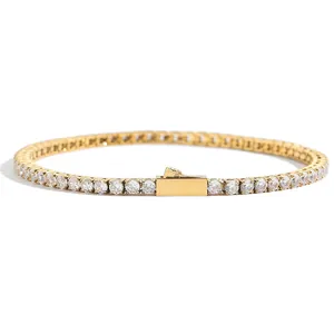Macro detail of golden tennis bracelet with round cubic zirconia and secure clasp closure