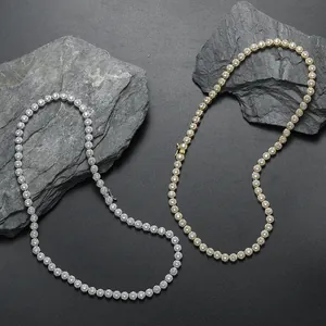 Iced out 6mm round cubic zirconia tennis chain in gold and silver plating on dark stones