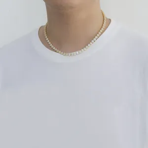 Close-up of a 6mm halo-set tennis necklace with round white zircons on a male model