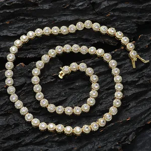 Macro shot of 6mm gold tennis chain with round zirconia on textured rock surface