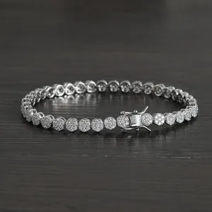 Silver finish 5mm round zirconia tennis bracelet with secure box clasp on wood background