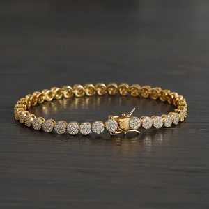 Detail of 5mm gold tennis bracelet featuring micro-pave cubic zirconia on a wood surface