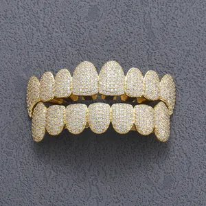 Macro shot of hip hop gold grillz set encrusted with sparkling white zirconia stones