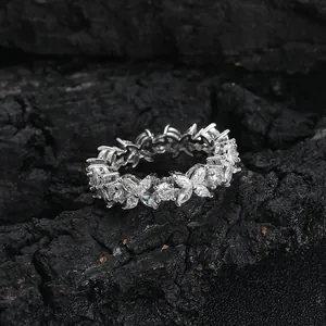 Macro detail of silver flower ring with marquise and round cut cubic zirconia on charcoal