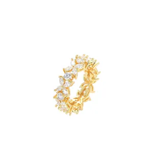 Macro shot of gold floral ring with cubic zirconia clover-shaped clusters