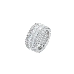 Detailed macro view of wide iced-out ring with baguette and round cut cubic zirconia