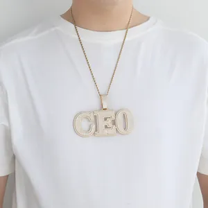 Detail of gold hip hop CEO letter pendant with pave zircon stones on a rope chain
