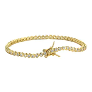 Detail of 2mm bezel set tennis chain bracelet with white cubic zirconia and gold plating