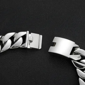 Polished silver stainless steel Cuban link chain necklace with secure clasp on black background