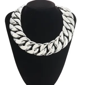 Chunky silver stainless steel Cuban link necklace displayed on a black velvet neck bust