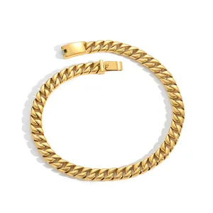 Macro detail of gold-plated cuban link chain with high-polished finish and box clasp