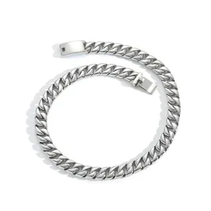 Macro view of silver stainless steel Cuban chain necklace with a square folding clasp