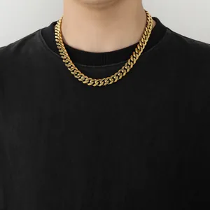 Close-up of 12mm gold-plated Cuban link necklace on a black shirt showing metallic shine
