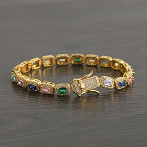 Luxurious gold tennis bracelet with colorful rectangular zircons and iced-out safety clasp