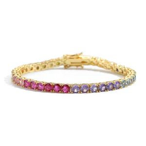 Detail showing rainbow gradient zircon tennis bracelet with gold setting and secure clasp