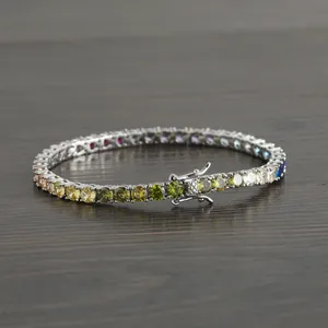 Macro detail of 4mm rainbow tennis bracelet with colorful zircons and secure clasp