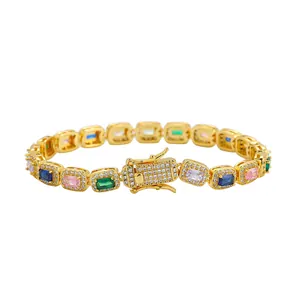 Detail of gold link bracelet with colorful rectangular cubic zirconia and pave diamonds