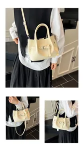 Detail showing cream woven texture and silver buckle on a stylish crossbody bucket bag