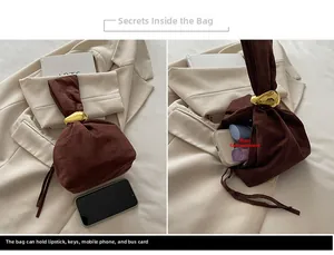 Detailed interior of a brown suede bucket bag showing storage space for phone and keys