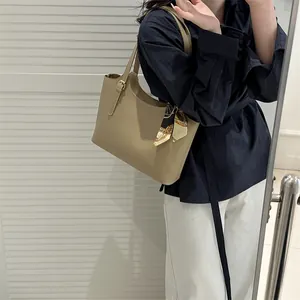 Khaki faux leather tote bag with vintage scarf detail and adjustable strap for women