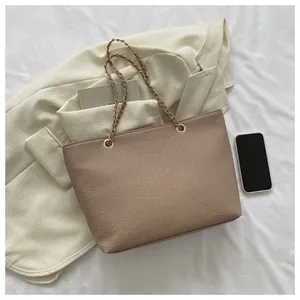 Pink crocodile-embossed tote bag with golden chain strap for 2025 autumn fashion