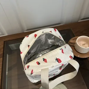 Detail of insulated strawberry print lunch bag with corduroy texture and foil lining